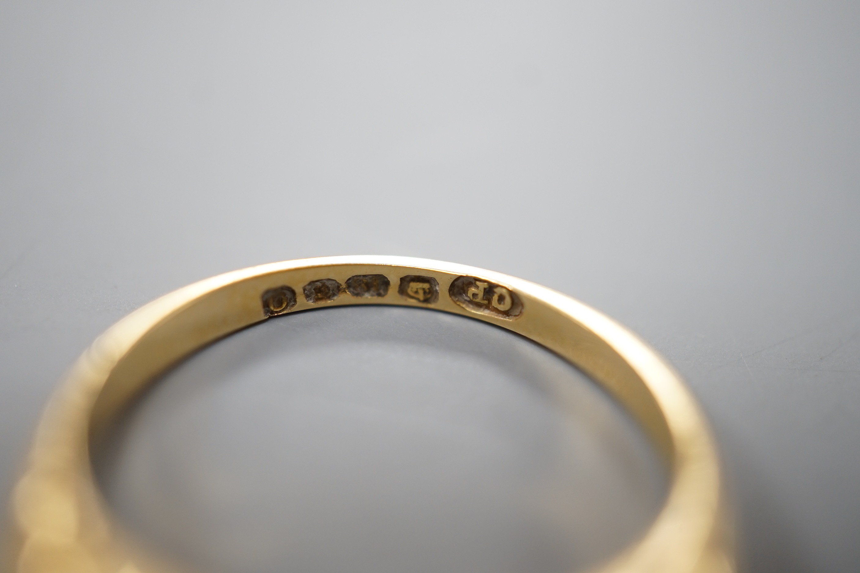 An early 20th century 18ct gold and graduated five stone diamond set half hoop ring, size N/O, gross weight 3.7 grams.